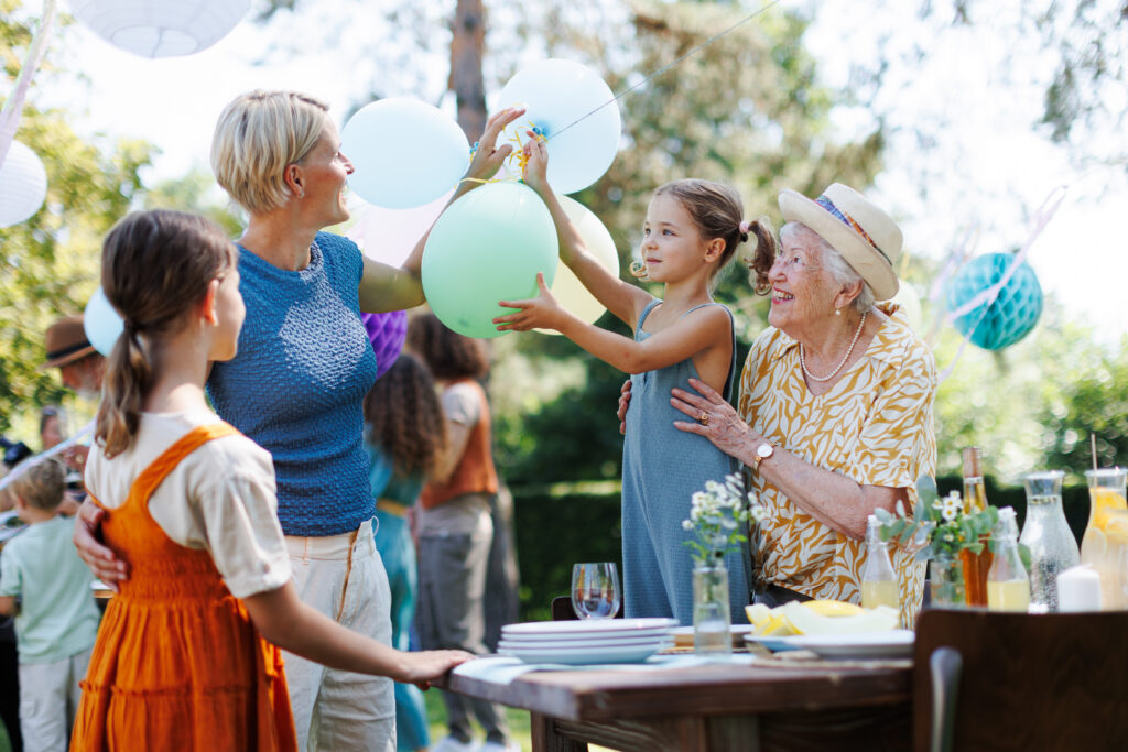 A smiling family enjoying a catered party together outdoors
