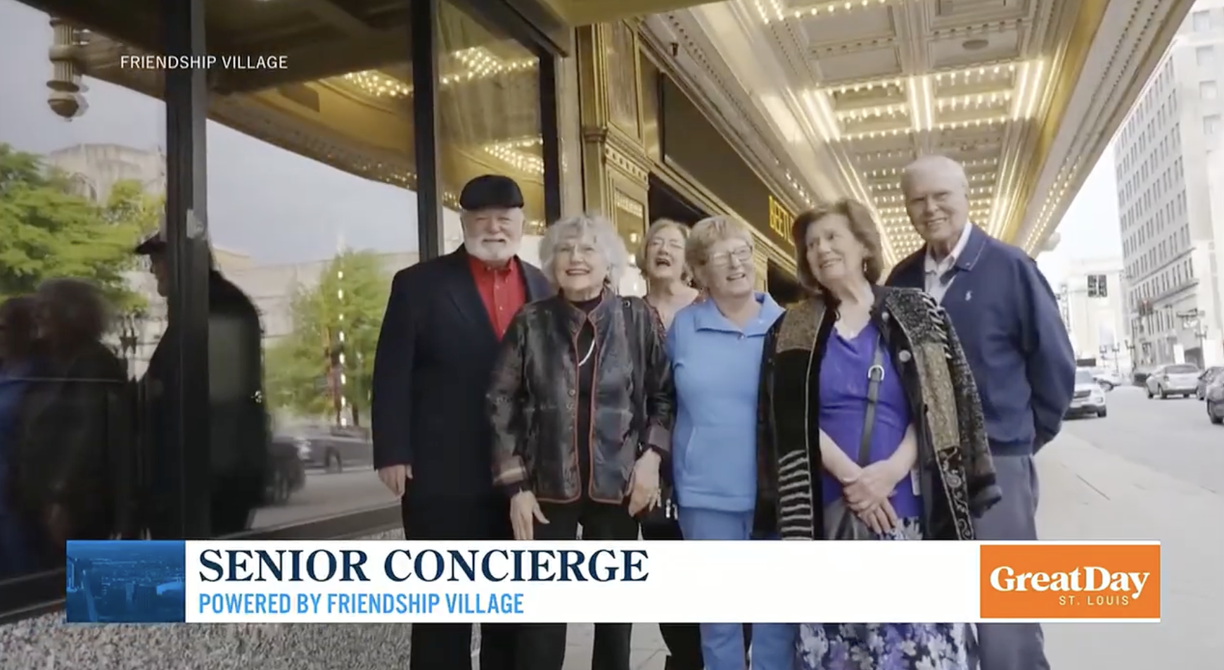 A group of smiling seniors poses together on a city sidewalk near a brightly lit building entrance. The image is labeled SENIOR CONCIERGE Powered by Friendship Village for Great Day St. Louis.